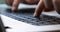 Man typing on a black keyboard macro