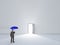 Man with umbrella in pure white room