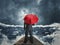 Man with umbrella standing on the pier