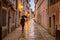 A man with an umbrella on the street in Porec town.