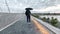 Man with umbrella walk on promenade heavy rain on new port of tallinn ,City Streets Pedestrian Windows Vitrines Buildings Houses L