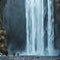 Man under waterfall in Iceland, adventure photo