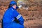 Man in underground tunnel works. Employee in safety suit works in medieval tunnel