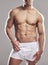 Man, underwear model and muscle with strong chest, abs and body with wellness in studio. Bodybuilder, exercise and