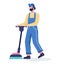 Man in the uniform cleaning floor using vacuum cleaner.