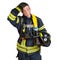 Man in uniform of firefighter holds hardhat and fire hose