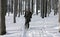 A Man in the Uniform Walking Through Winter Forest