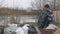 Man unloads garbage bags from wheelbarrow