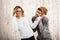 Man unnerve his girlfriend speaking on phone over wooden background.