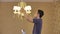 A man unscrews a burnt out light bulb