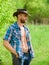 Man unshaven face muscular torso cowboy. Farm concept. Guy bearded cowboy in nature. Macho six packs torso wear rustic