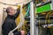 A man untangles many utp wires in racks with computer equipment. Specialist switches communication lines in the server room. The t