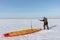 Man unwinding slings at kite on snow, Novosibirsk,Russia