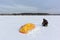 Man unwinding slings near a kite in the snow, Ob reservoir, Novosibirsk, Russia