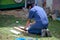 Man use cutting machine cut quarry tile at garden