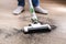 A man uses a bagless vertical cordless vacuum cleaner to clean floor