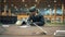 A man uses drill while preparing discarded garbage for recycling.