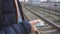 a man uses a mobile phone standing at a railway stop. 4k footage