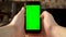 The man uses the phone. Hand makes swipe right on smartphone with green screen. Chroma key.