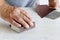 Man uses a sandpaper to restore wooden surface