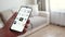 Man uses a smartphone app for augmented reality interior design to select the type and color of living room furniture