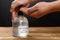 Man using 75 percent alcohol instant hand sanitizer to clean his hands