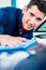 Man using an absorbent towel for drying the surface of a car