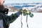 Man using binoculars on snow covered mountain