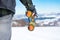 Man using binoculars on snow covered mountain