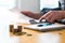 Man using calculator and reading financial document paper.