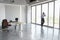 Man Using Cellphone Against Glass Wall In Empty Office