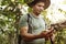 Man using compass in a forest