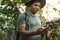 Man using compass in the jungle