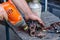 A man using an electric drill polishes the seats of the driveshaft bearings.