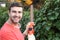 Man using electric hedge trimmer