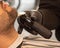 Man using electric razor to groom his facial hair