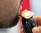 Man using electric razor to groom his facial hair