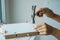 man using hammer hammering a nail into wooden boards, assembling or repairing furniture at home. DIY, Renovation, repairing and