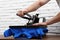 Man using heat press machine at table near brick wall, closeup