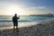 Man using his camera on the beautiful beach.