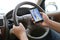 Man using his mobile phone to navigate with map application while driving. Dangerous driver. Concept and idea of safety driving