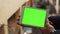Man using horizontal tablet with green screen. Close-up shot of man`s hands with tablet. Chroma key. Close up
