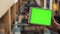 Man using horizontal tablet with green screen. Close-up shot of man`s hands with tablet. Chroma key. Close up