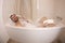 Man using land line telephone in the bathtub