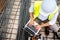 Man using laptop on construction site. Building industry details