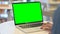 Man Using Laptop with Green Chroma Key Screen, Rear View