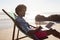 Man using laptop while relaxing in a beach chair on the beach