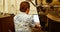 Man using laptop while sitting besides coffee roasting machine