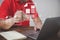 A man using laptop working on an old wood table use a pen sign electronic document with copy space. e-document management,