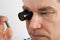 Man using a magnifying loupe